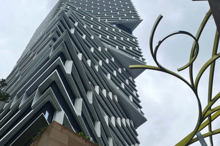 a traffic light sitting below a tall building