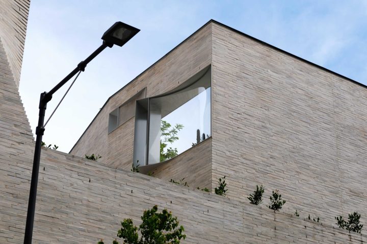a large brick tower with a clock on the side of a building